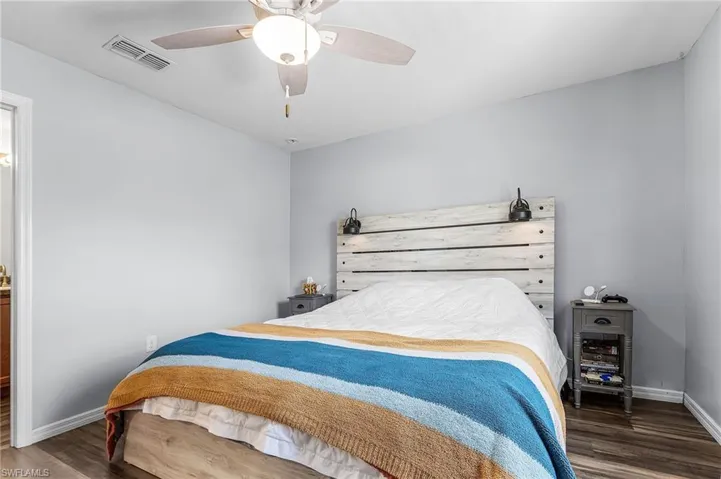 Bedroom featuring dark wood-style floors and ceiling fan