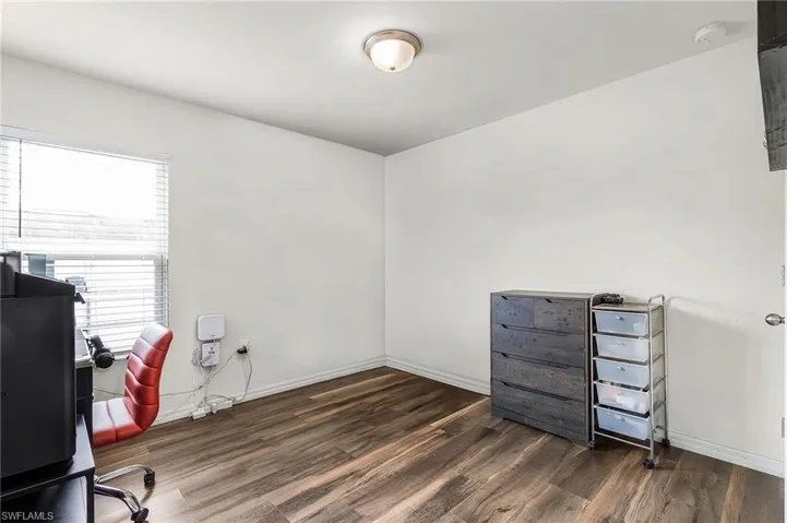 Unfurnished office featuring dark wood-style flooring