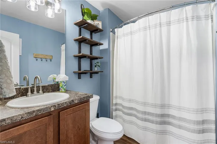 Bathroom featuring vanity and curtained shower