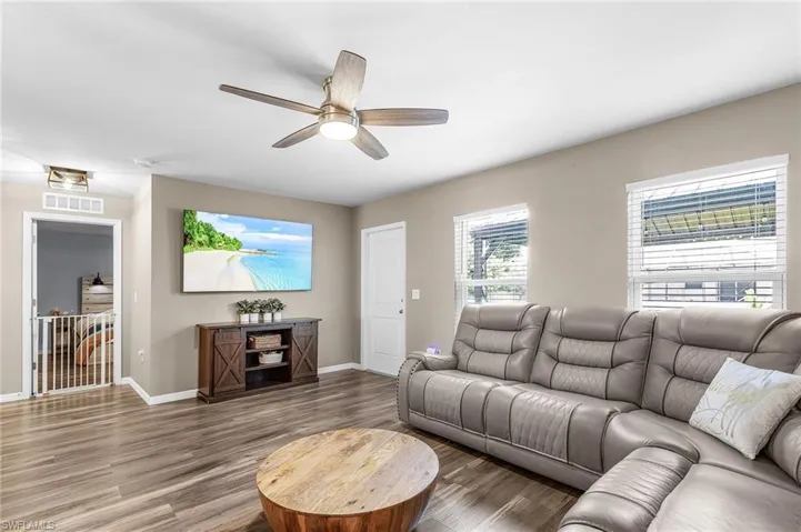 Living area with wood finished floors and a ceiling fan