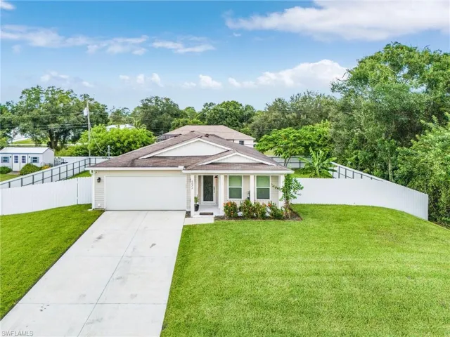 Single story home with driveway and an attached garage