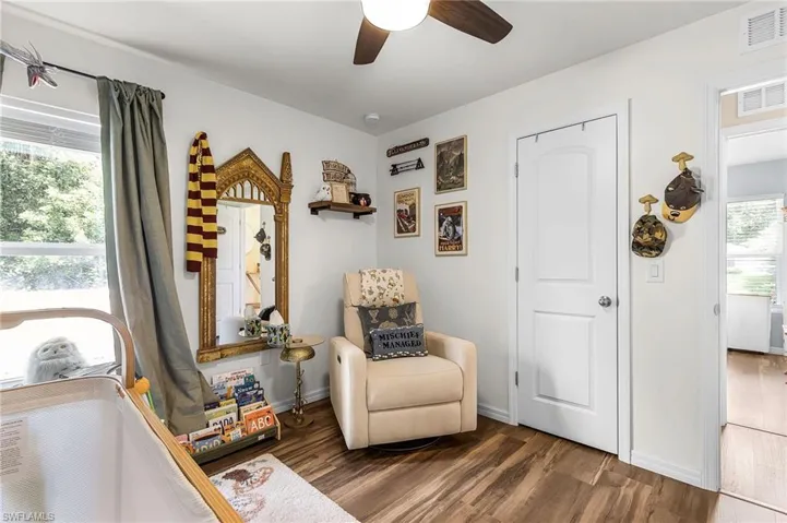 Sitting room with wood finished floors and a ceiling fan