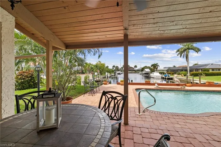View of pool featuring a water view and a patio area