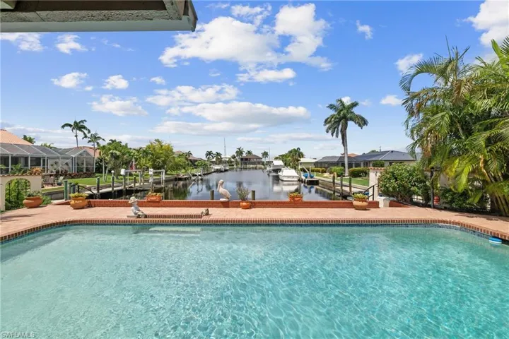 View of swimming pool featuring a lanai and a water view