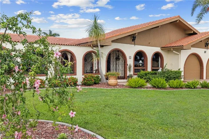 Mediterranean / spanish house featuring a front lawn