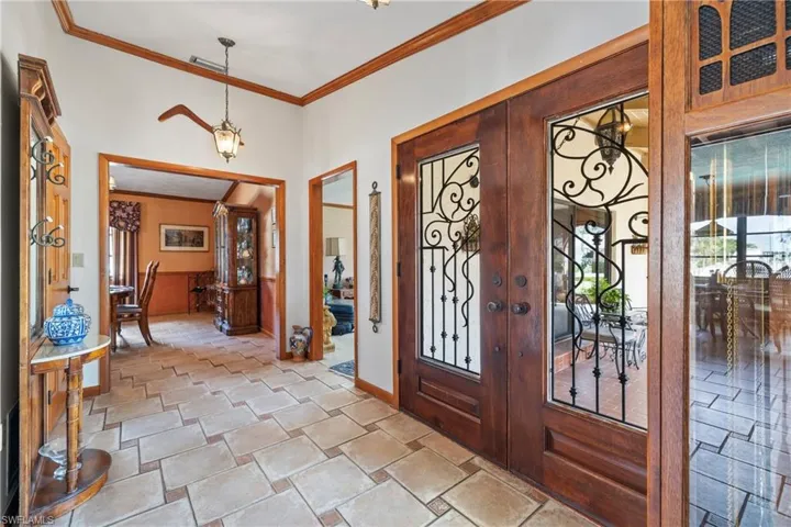 Entryway featuring crown molding and french doors