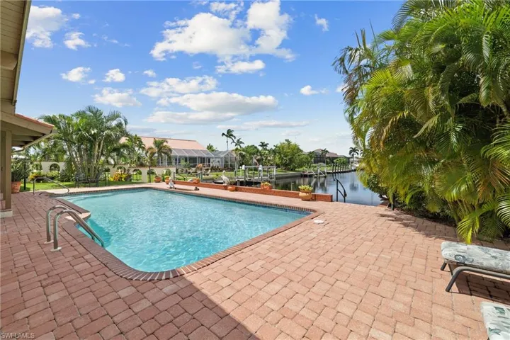 View of pool with a water view and a patio area