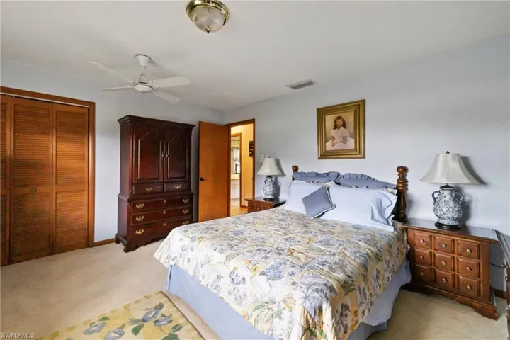 Bedroom featuring carpet flooring, ceiling fan, and a closet
