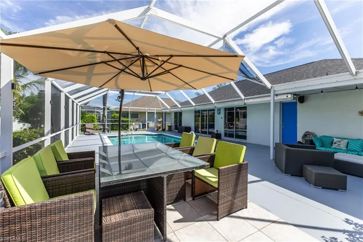View of patio / terrace with an outdoor living space, a sunroom, glass enclosure, and an outdoor pool