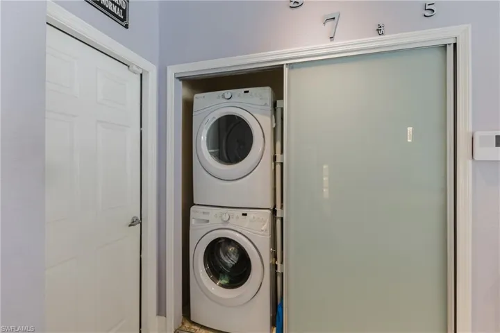 Laundry room featuring estacked washer and dryer