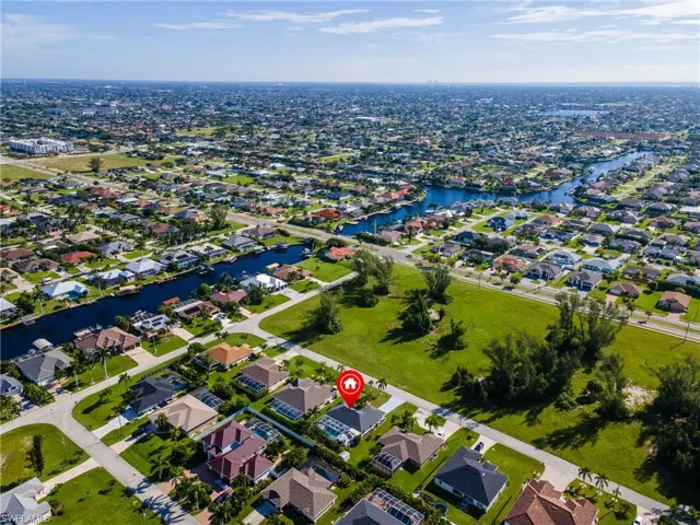 Aerial view of residential area featuring a nearby body of water