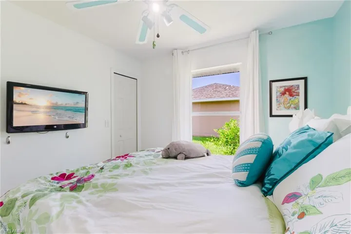 Bedroom with ceiling fan and a closet