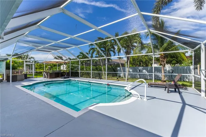 View of pool featuring a lanai, a patio, and a sunroom