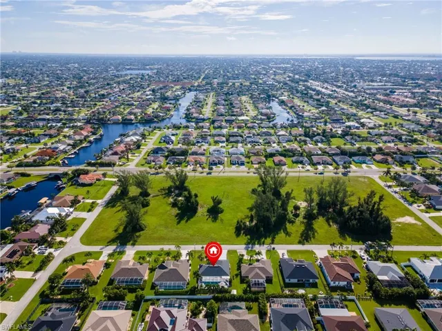 Aerial view of property's location with nearby suburban area and a nearby body of water