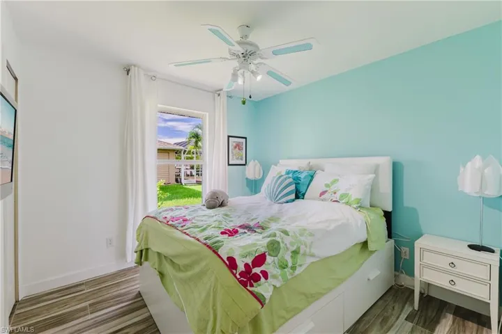 Bedroom with wood tiled floors and ceiling fan
