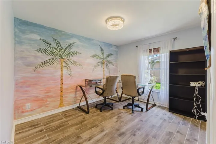 Office area featuring baseboards and light wood-style tiled floors