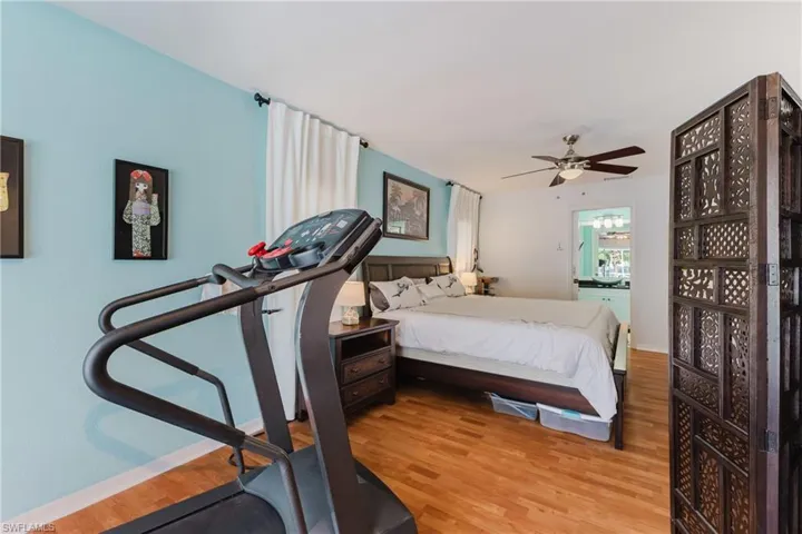 Bedroom with light wood finished floors and ceiling fan