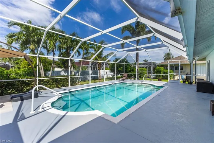 Outdoor pool featuring a patio, a lanai, and a sunroom