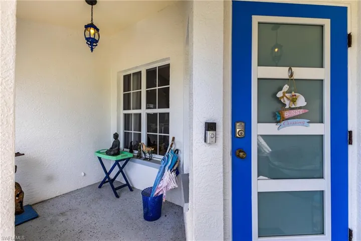 Doorway to property featuring stucco siding