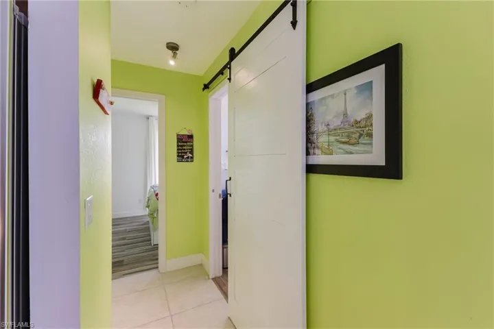 Hall featuring a barn door and light tile patterned floors