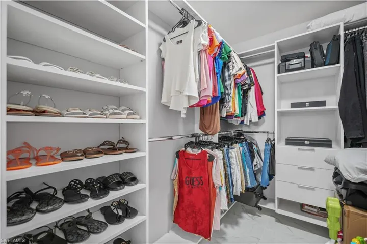 Spacious closet featuring tile flooring