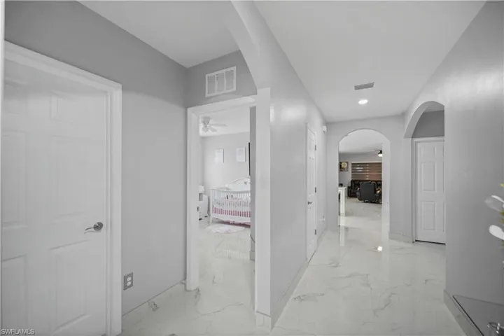 Hall with light tile flooring