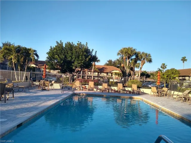 Community pool with a patio
