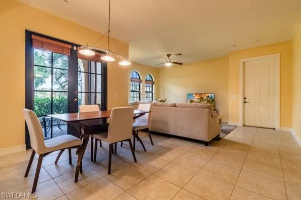 Tiled dining area featuring french doors, ceiling fan, and plenty of natural light