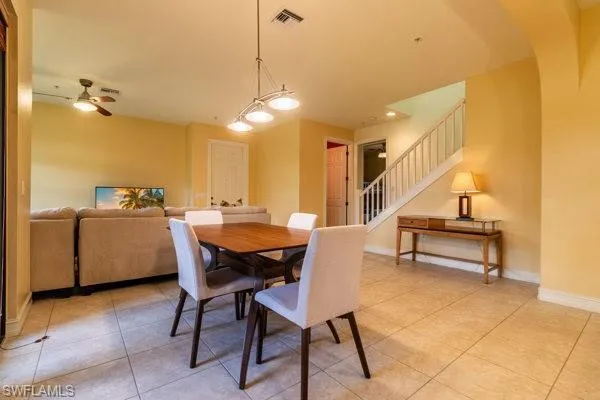 Tiled dining room featuring ceiling fan