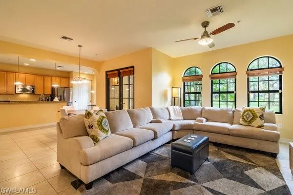Tiled living room featuring ceiling fan