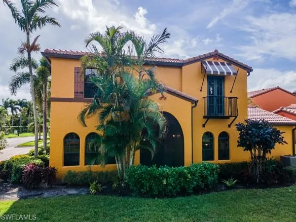 Mediterranean / spanish home with central air condition unit and a front lawn