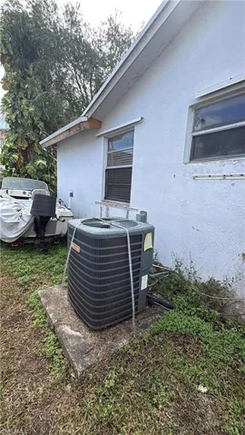 Exterior view of stucco siding and a central air condition unit