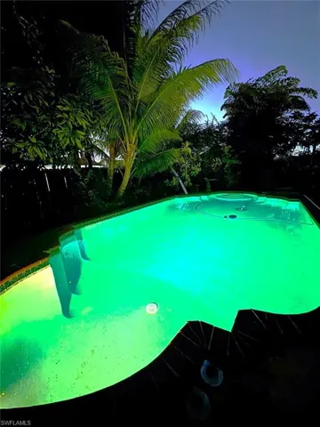 Pool at dusk featuring an outdoor pool