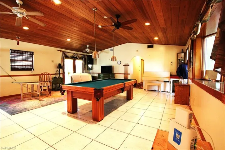 Game room with ceiling fan, arched walkways, billiards, light tile patterned flooring, and recessed lighting