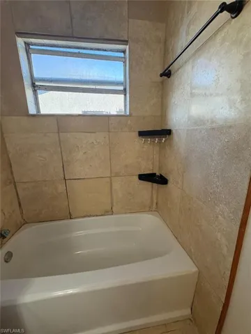 Full bathroom with tub / shower combination