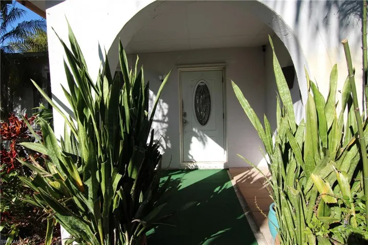 Property entrance with stucco siding