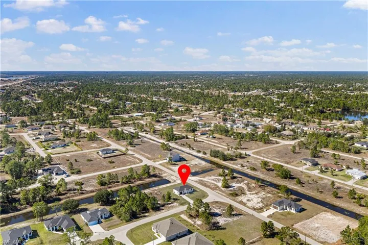 Aerial view of property's location with nearby suburban area