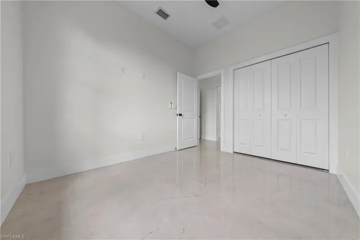 Unfurnished bedroom featuring a closet and ceiling fan