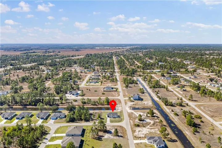 Aerial view of property's location with nearby suburban area