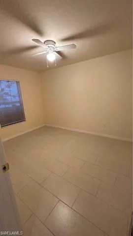Spare room with baseboards and ceiling fan