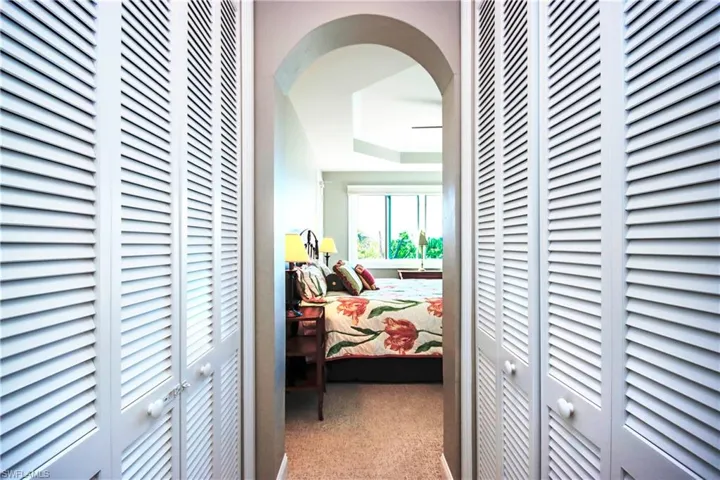 Arched way for primary bedroom his & her closets