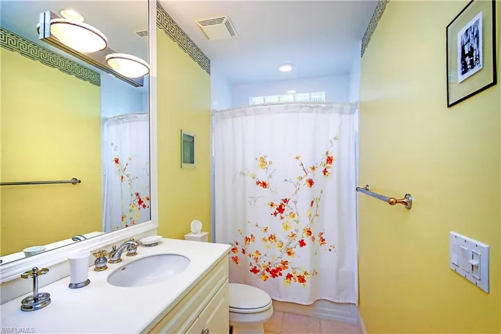 Full 2nd bathroom with vanity, toilet, tile patterned flooring, and shower / bath combo with shower curtain