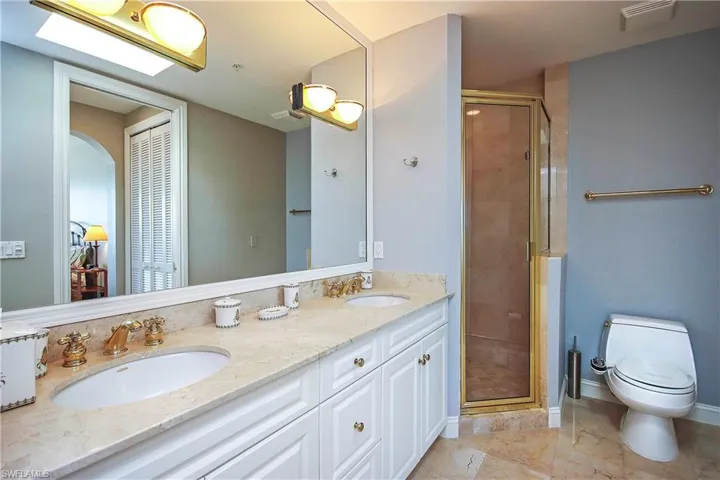 Double vanities, toilet & bidet, and separate shower