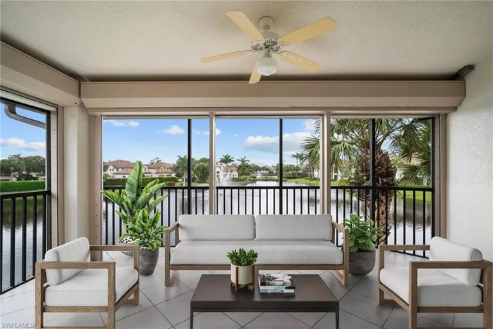 Sunroom with a water view and ceiling fan