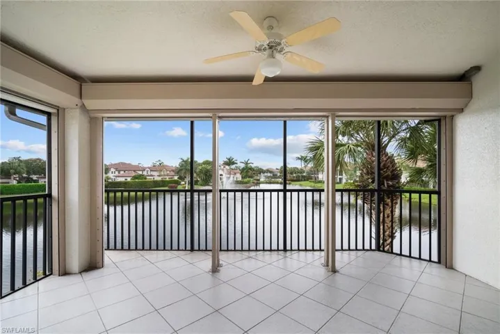 Unfurnished sunroom with a water view and ceiling fan