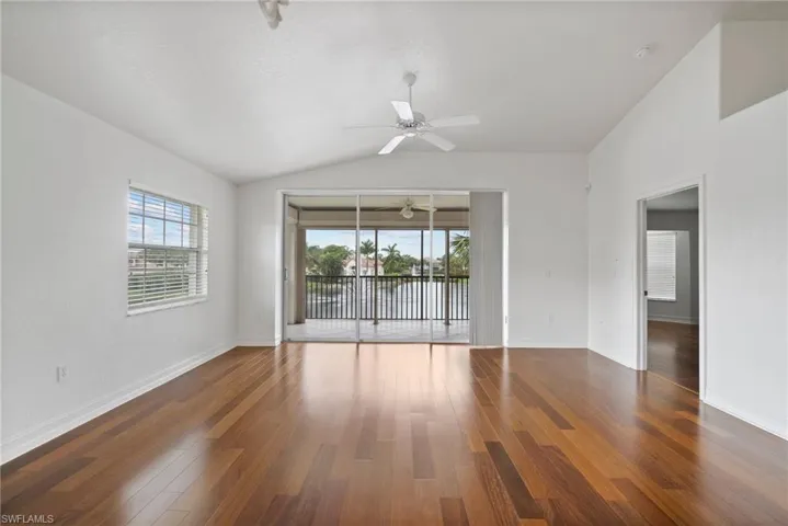 Spare room featuring ceiling fan, vaulted ceiling, and dark hardwood / wood-style floors