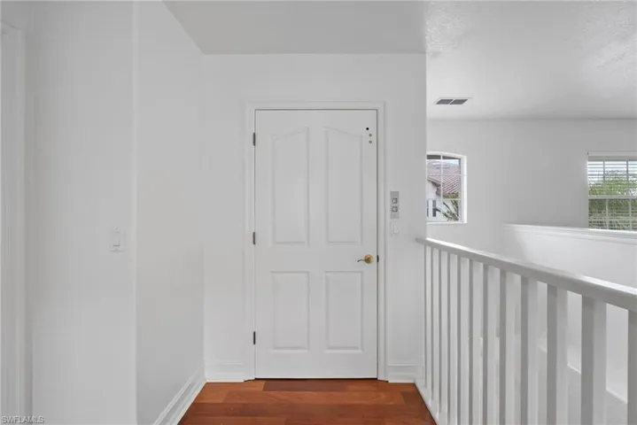 Corridor featuring hardwood / wood-style flooring