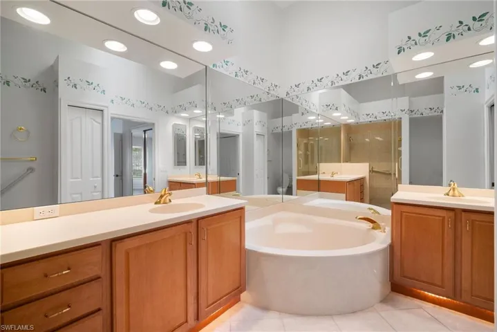 Bathroom featuring vanity, separate shower and tub, and tile patterned flooring
