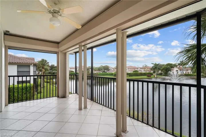 Unfurnished sunroom featuring a water view and ceiling fan