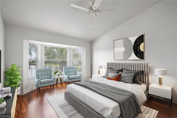 Bedroom featuring ceiling fan, vaulted ceiling, and dark hardwood / wood-style flooring
